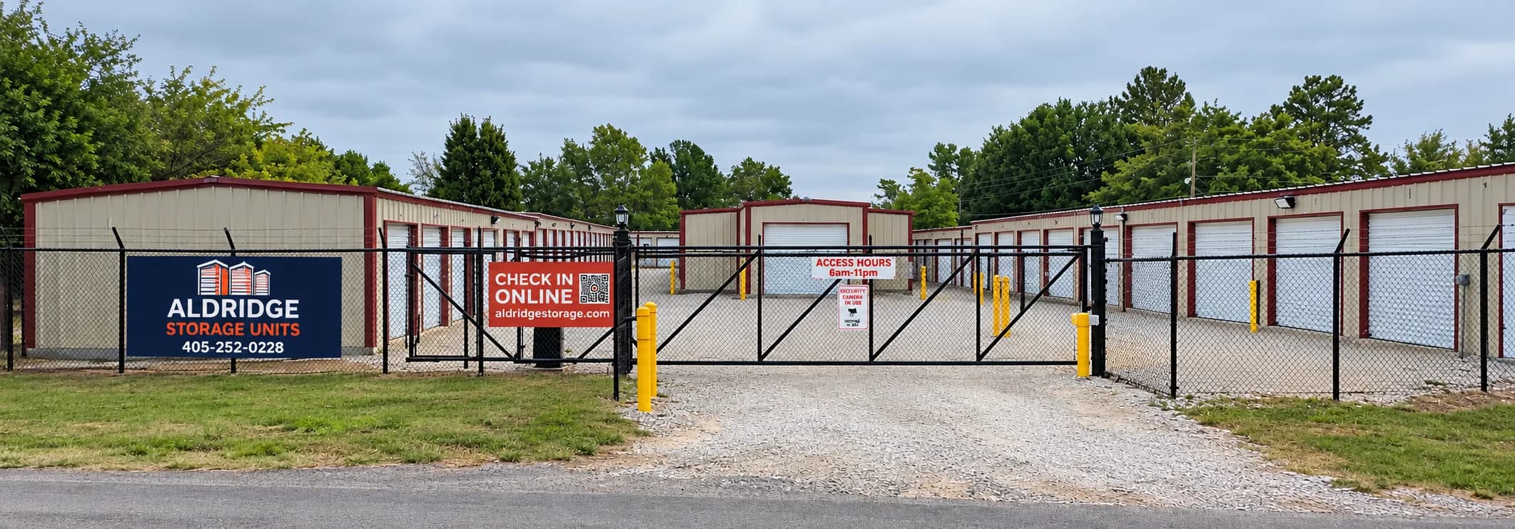 Gated entrance to Aldridge Storage in Shawnee with drive-up storage units behind a black security fence